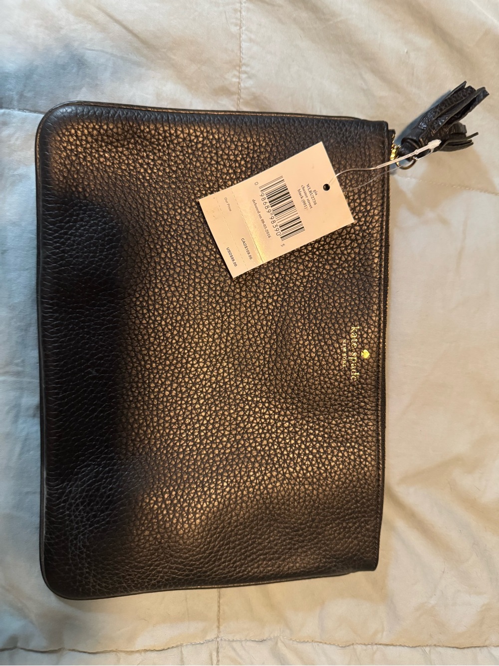 kate spade black pebbled leather zip toiletry clutch with tassel